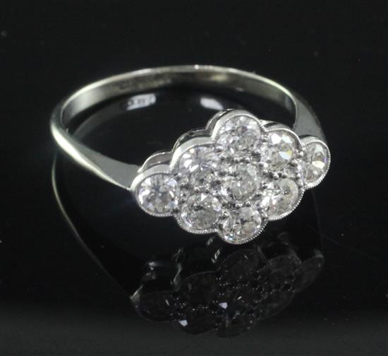 An 18ct gold, platinum and nine stone diamond cluster ring, size Q.